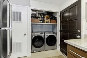 Integrated laundry closet featuring a stacked washer and dryer