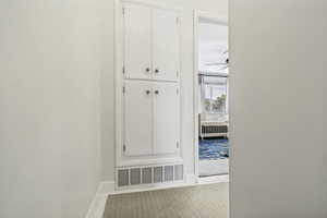 Built-in white cabinetry featuring four doors and brass-tone hardware