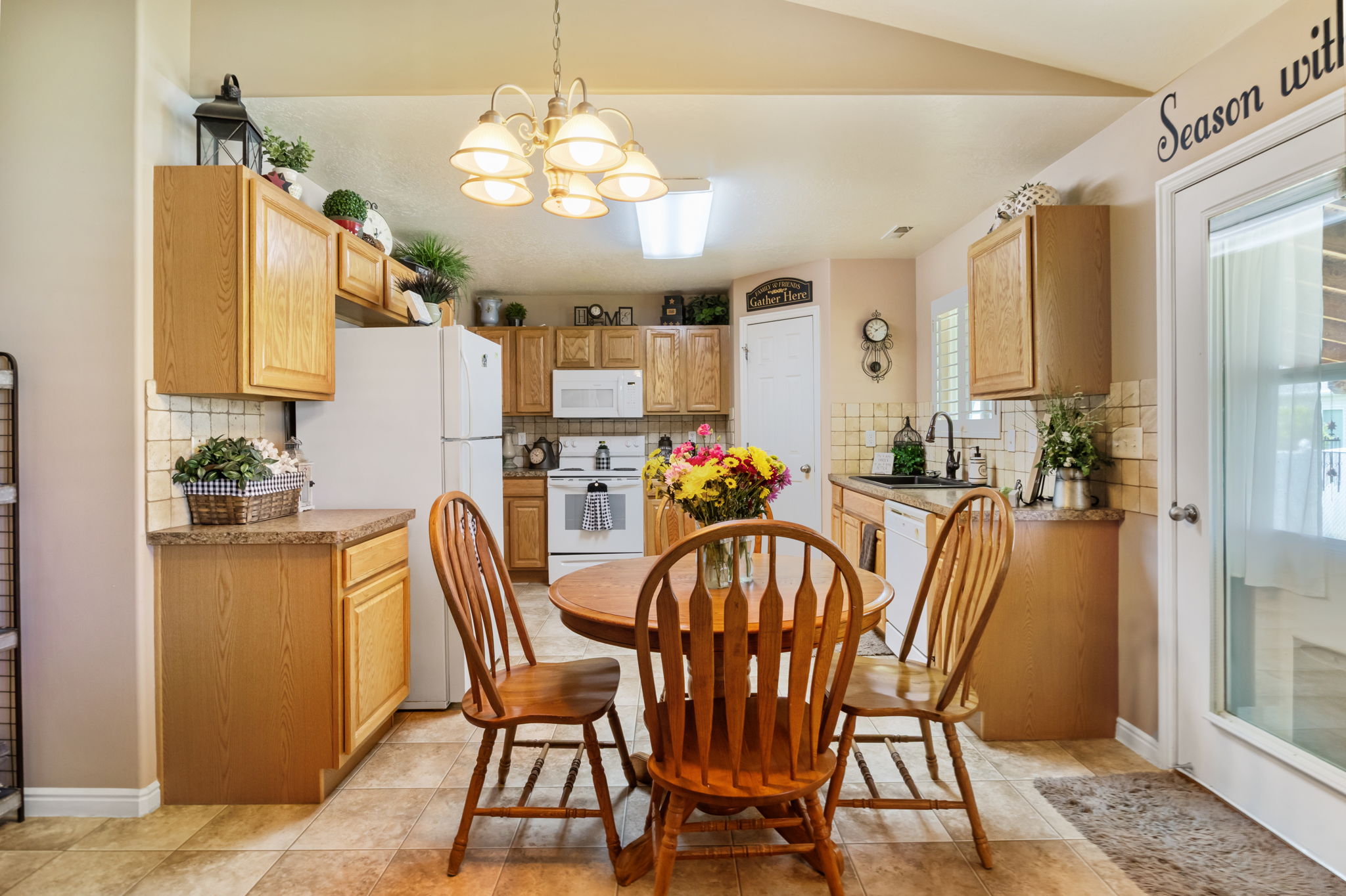 Kitchen with light wood-finish cabinetry and a complementary tile backsplash