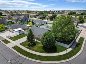 Corner lot property featuring mature trees and a manicured lawn