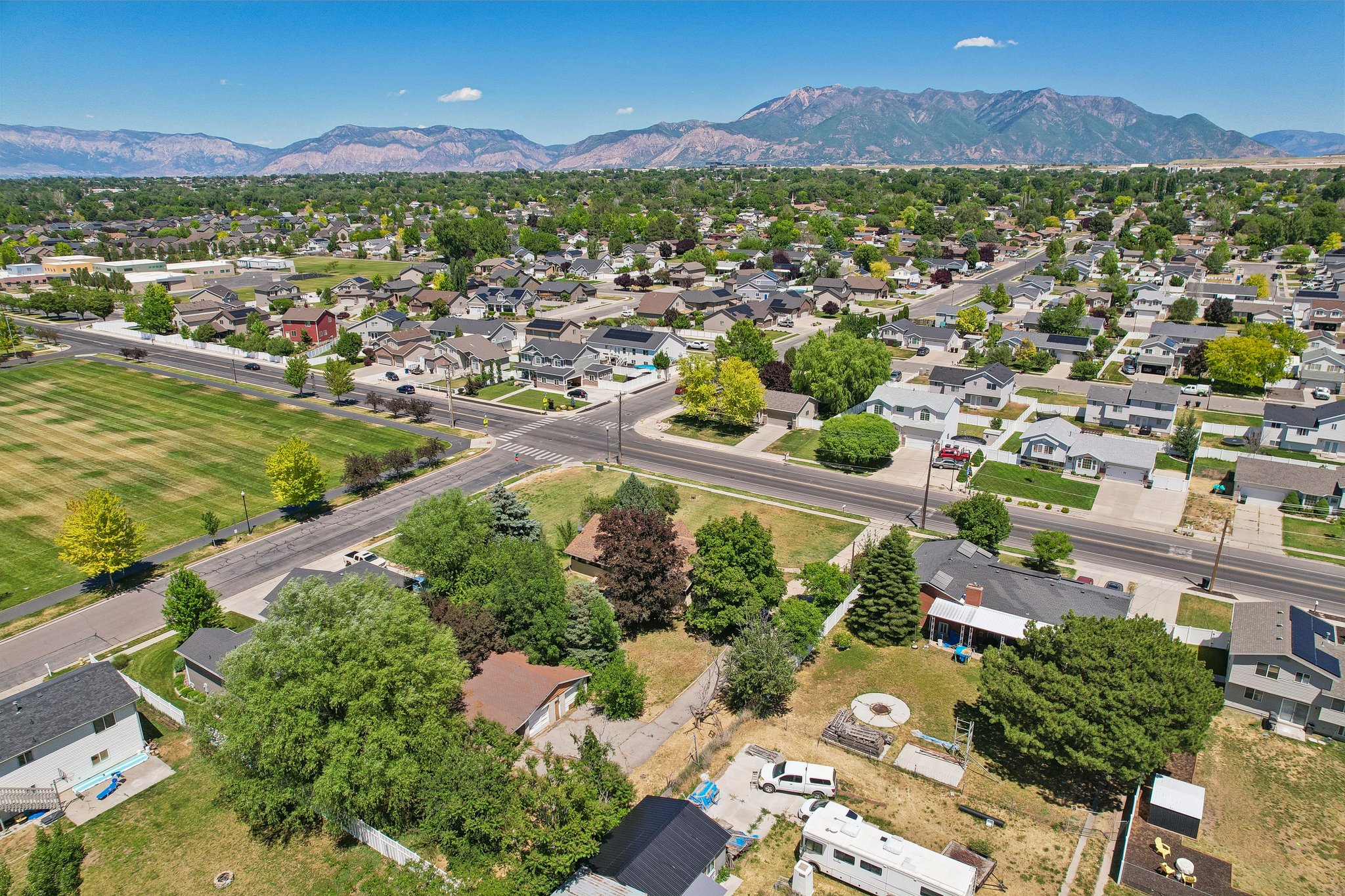 Expansive residential area featuring a variety of homes, mature trees, and a mountain backdrop
