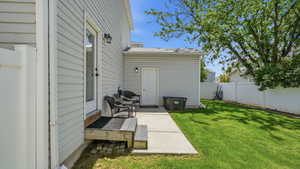 Poured concrete patio with direct outdoor access and a wood deck landing