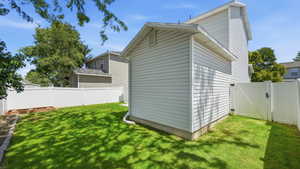 Expansive green lawn surrounded by a white privacy fence