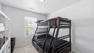 Room featuring soft gray wall paint, recessed ceiling vent, and a single window with white blinds