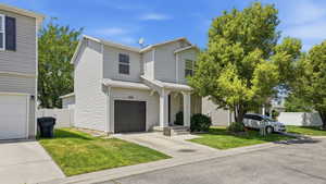 Two-story siding exterior with an attached single-car garage, covered entry, and dedicated driveway