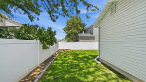 Expansive grass lawn with perimeter white vinyl fencing