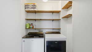 Dedicated laundry area featuring a washer and dryer set