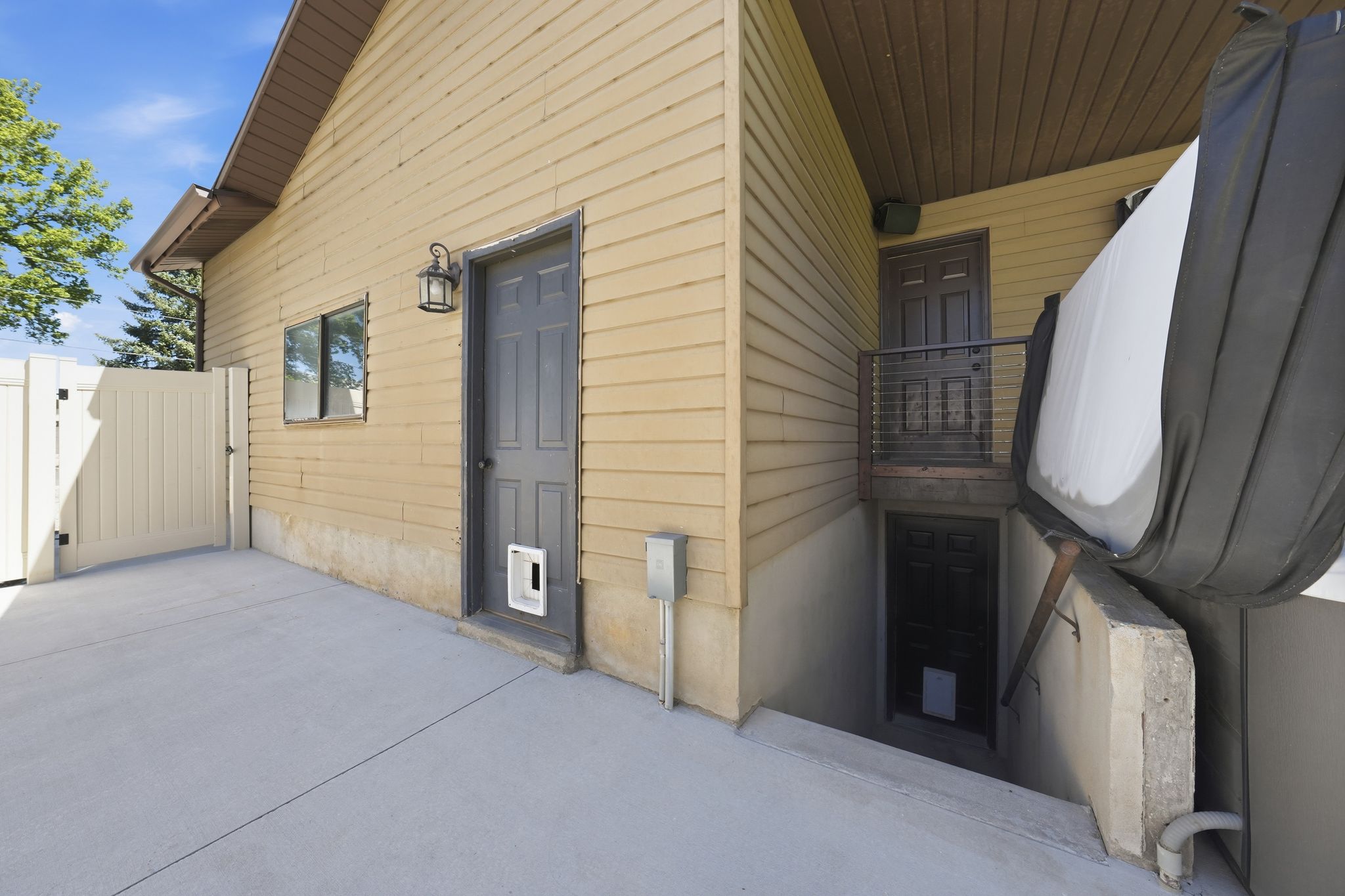 Exterior featuring horizontal siding, a concrete patio, and a privacy fence