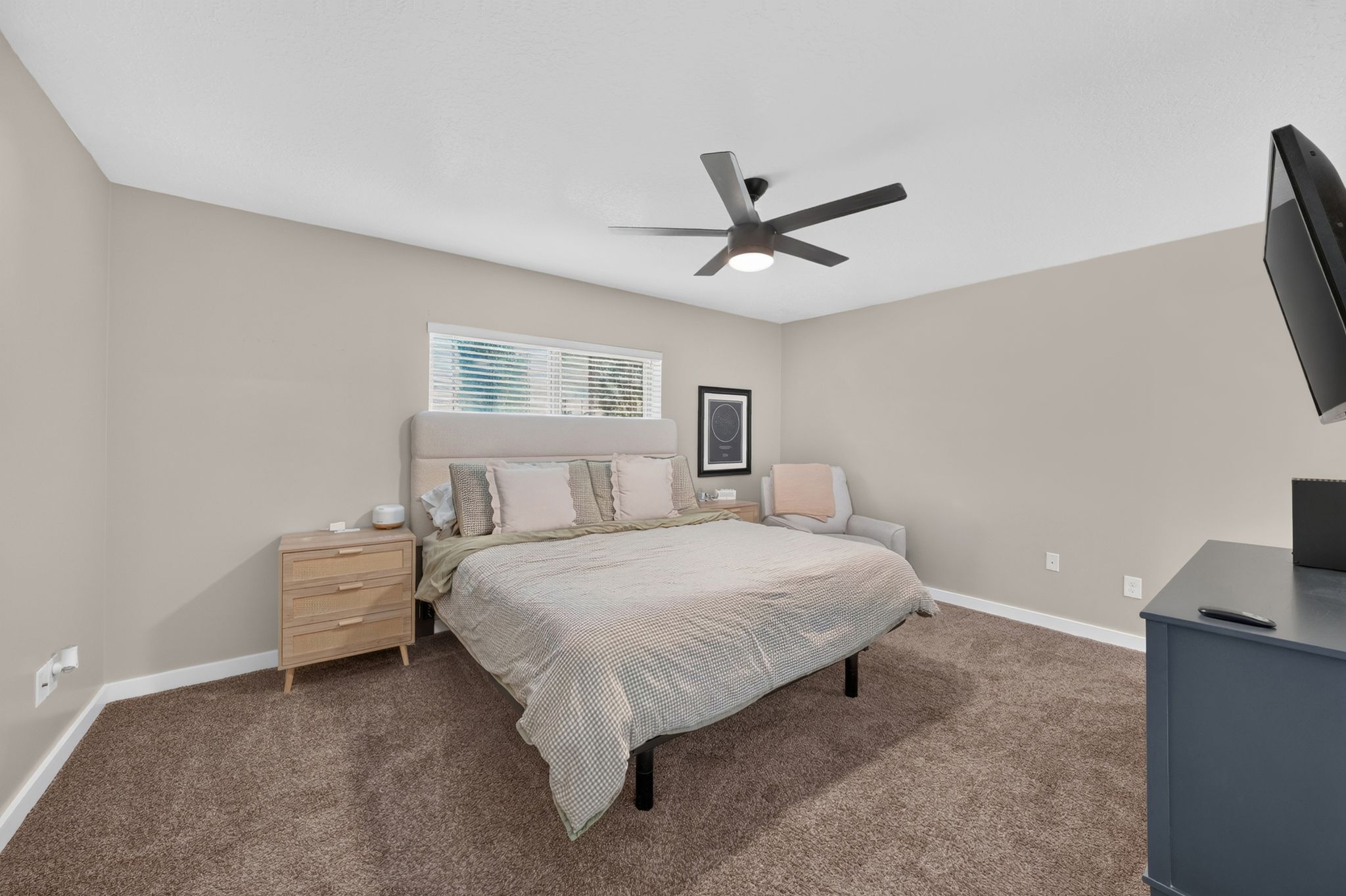 Primary Bedroom featuring wall-to-wall carpeting, neutral wall tones, a modern ceiling fan with integrated lighting, and a horizontal window with blinds