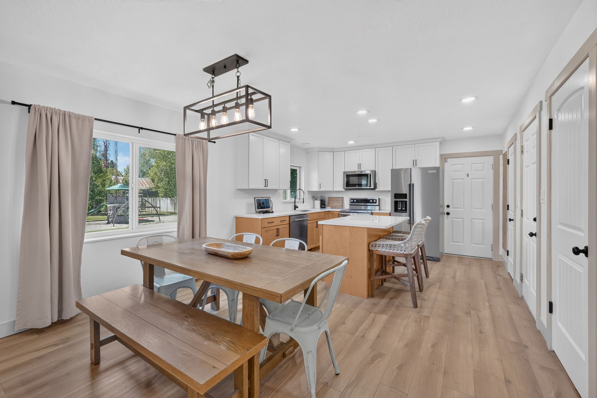 Open-concept kitchen and dining area with wood-finish flooring