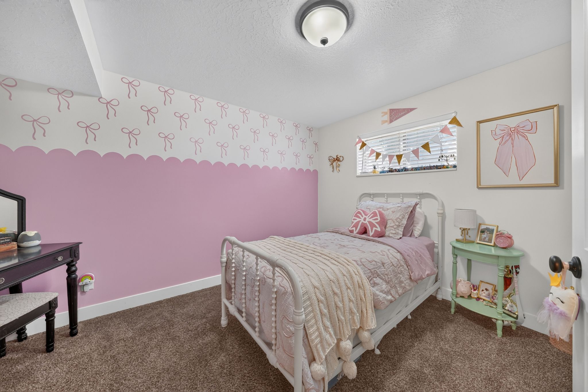 Carpeted room featuring a window with horizontal blinds, a flush mount ceiling light, and a two-tone wall with a scalloped border