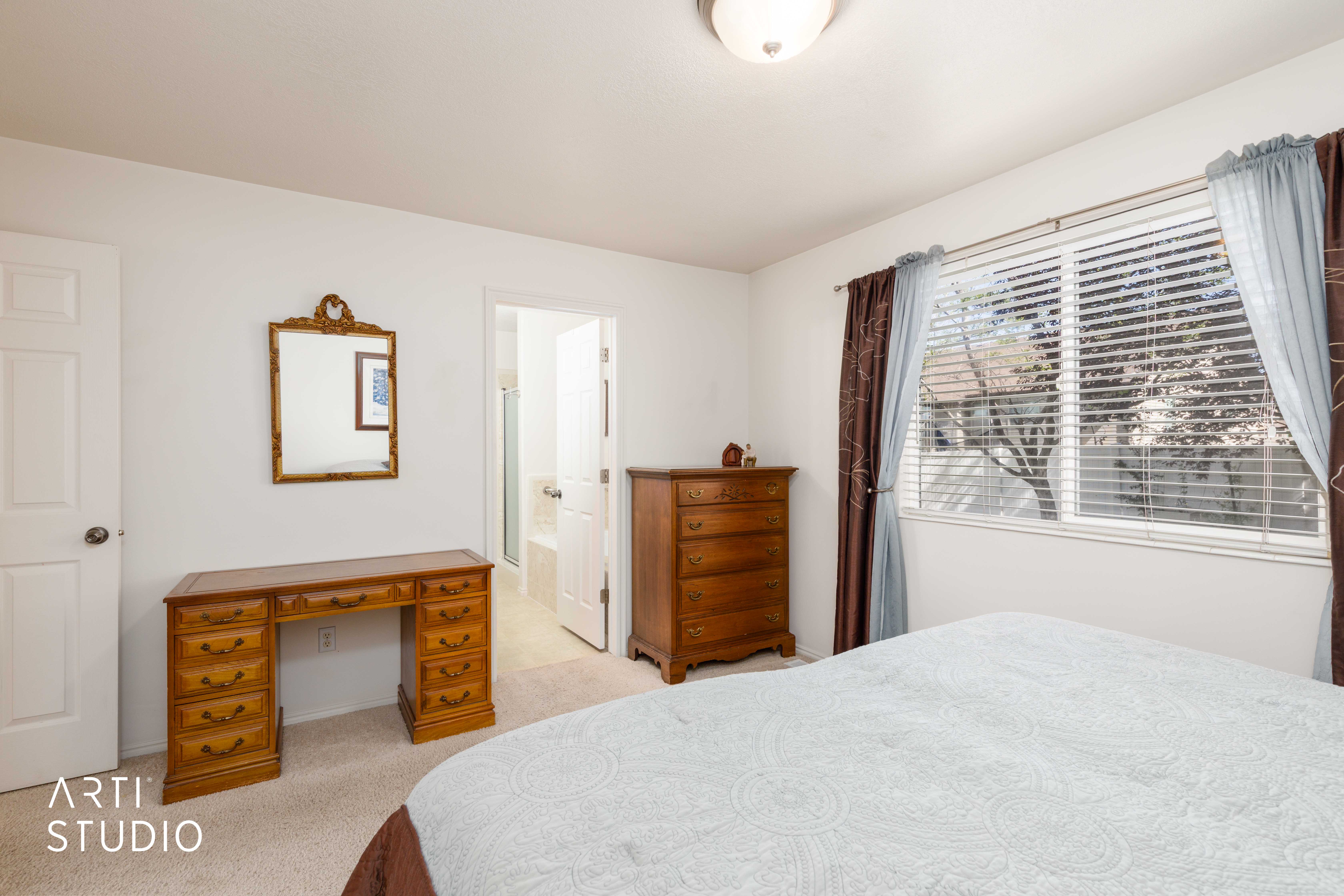 Bright room featuring neutral carpeting and white walls