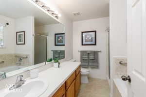 Bathroom vanity featuring a single sink, chrome faucet, and wood-finish cabinetry