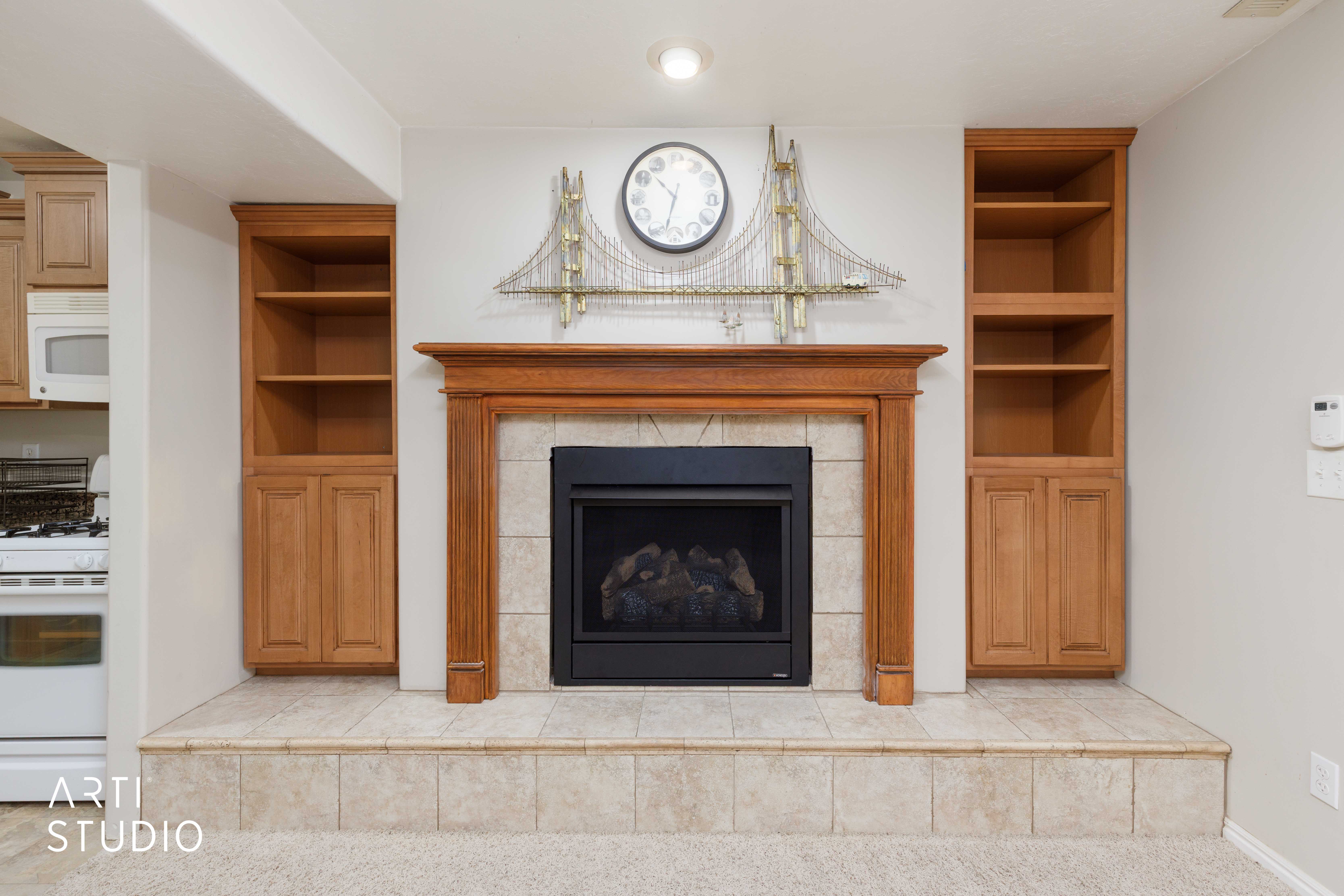 Fireplace with a wood-finish mantel and surround, set on a tiled hearth