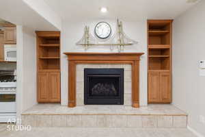 Fireplace with a wood-finish mantel and surround, set on a tiled hearth