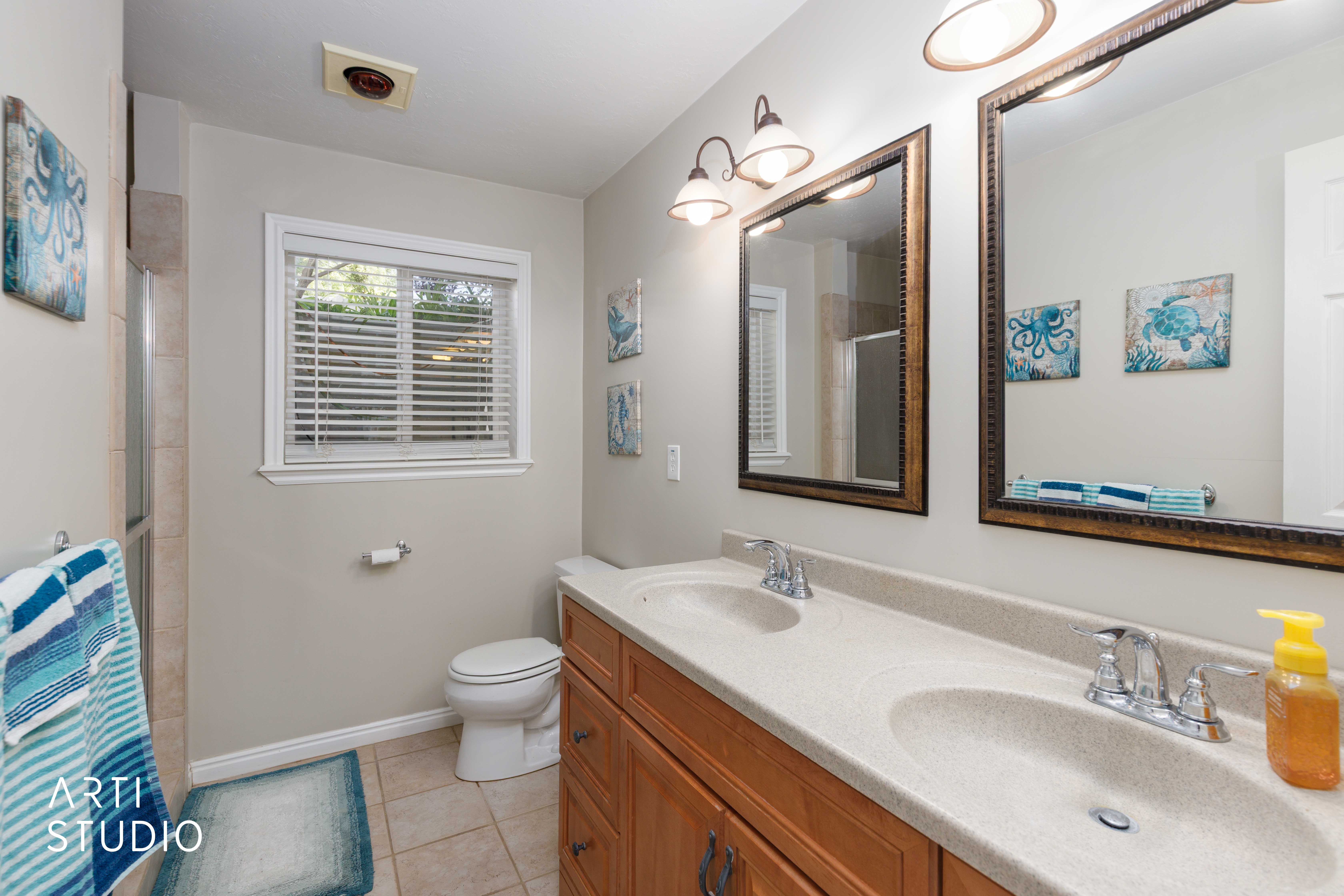 Dual vanity featuring integrated sinks and chrome fixtures