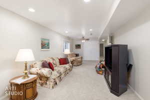 Spacious room featuring light-toned walls, recessed lighting, and soft carpeting