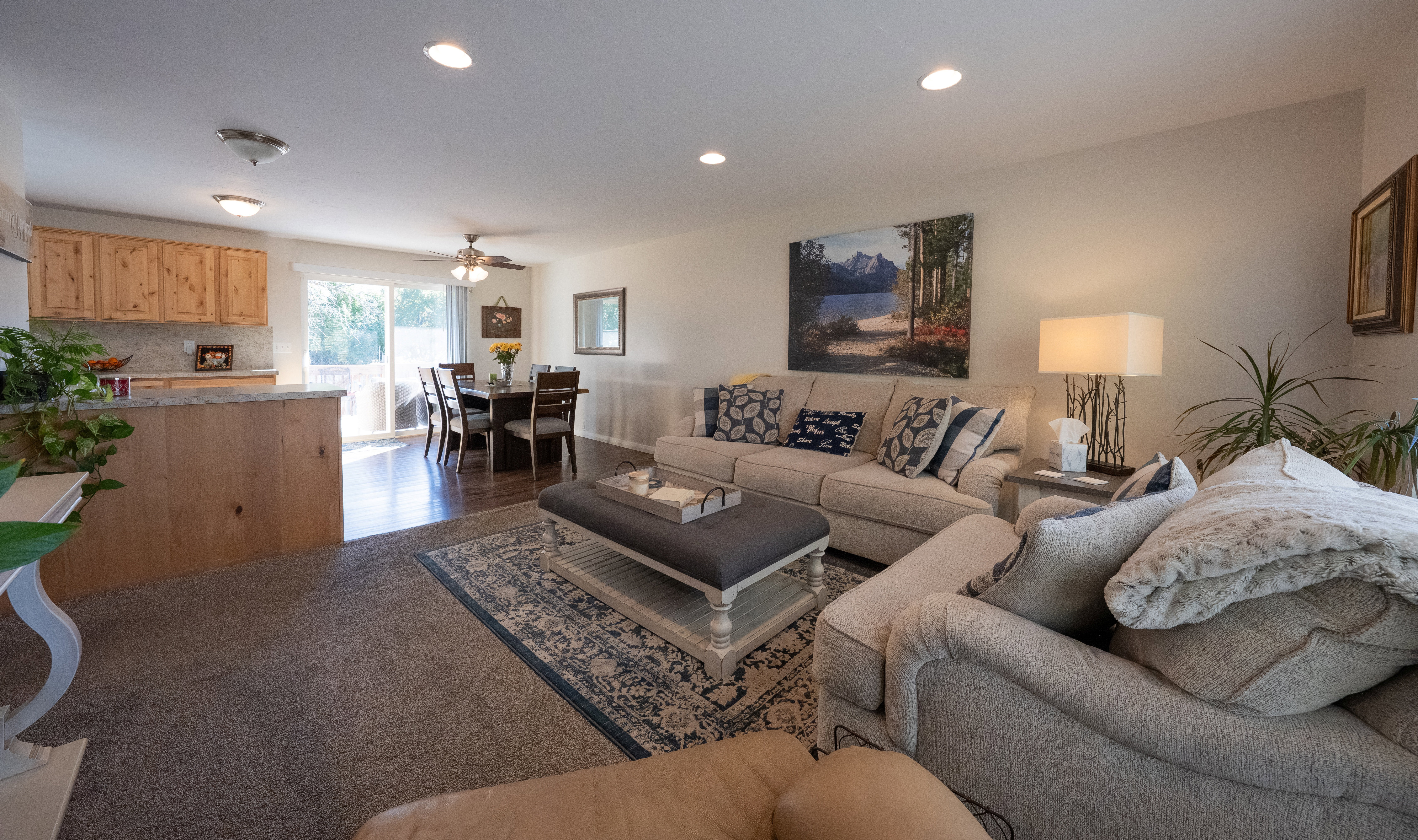 Open-concept living space with carpet flooring and recessed lighting