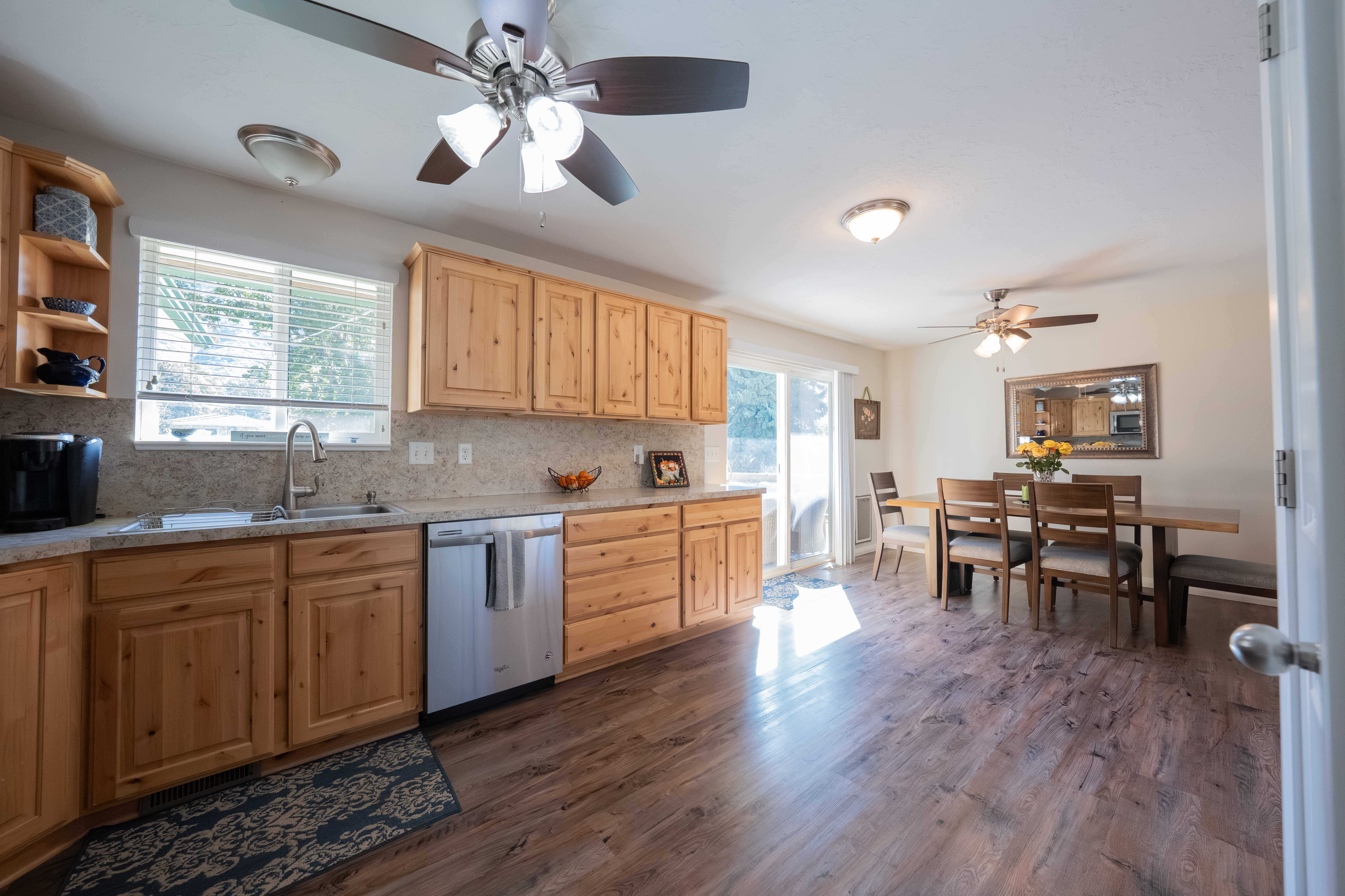 Spacious kitchen and dining area featuring wood-finish flooring