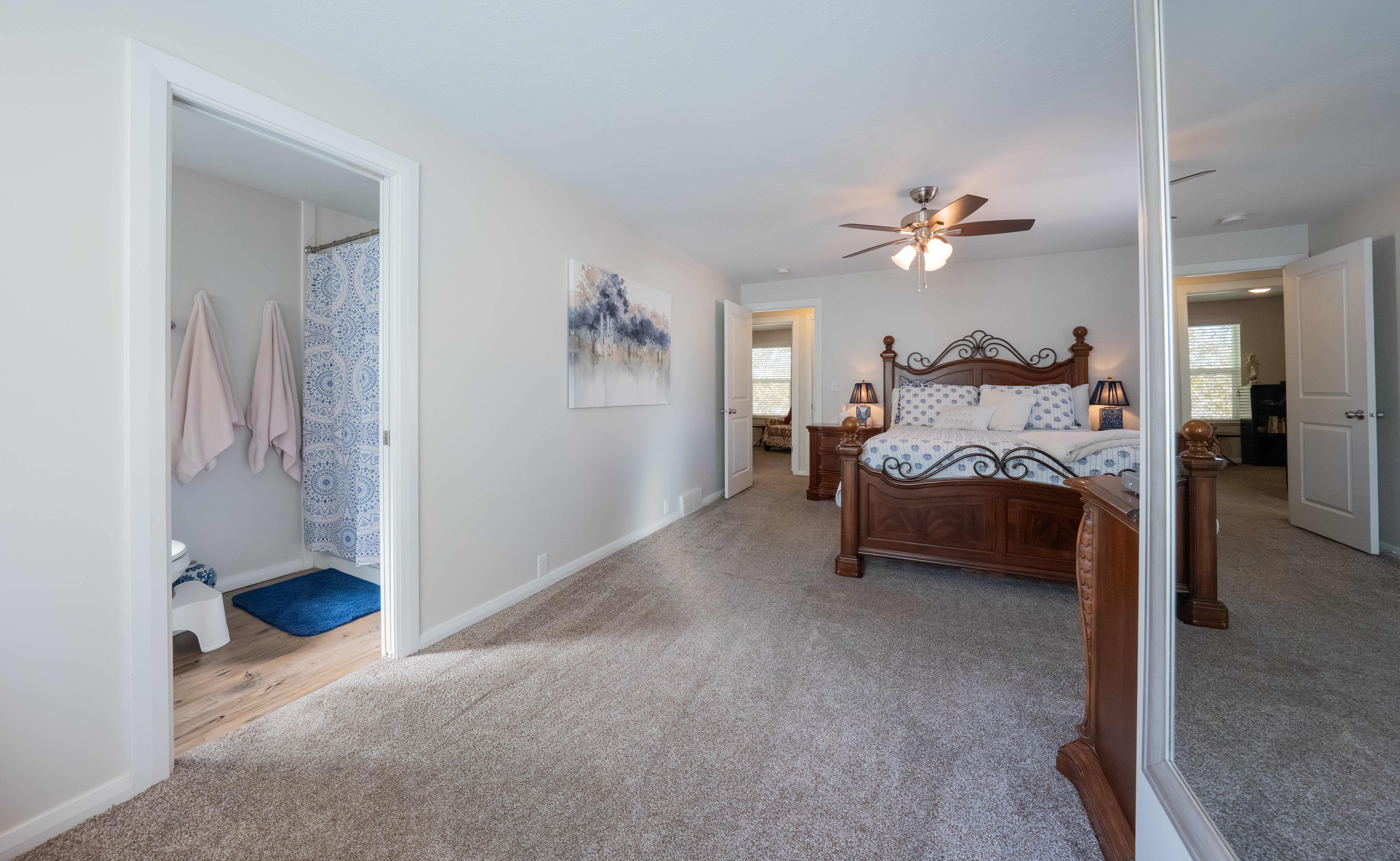 Bedroom featuring neutral wall paint, gray carpet flooring, and a ceiling fan with light fixture