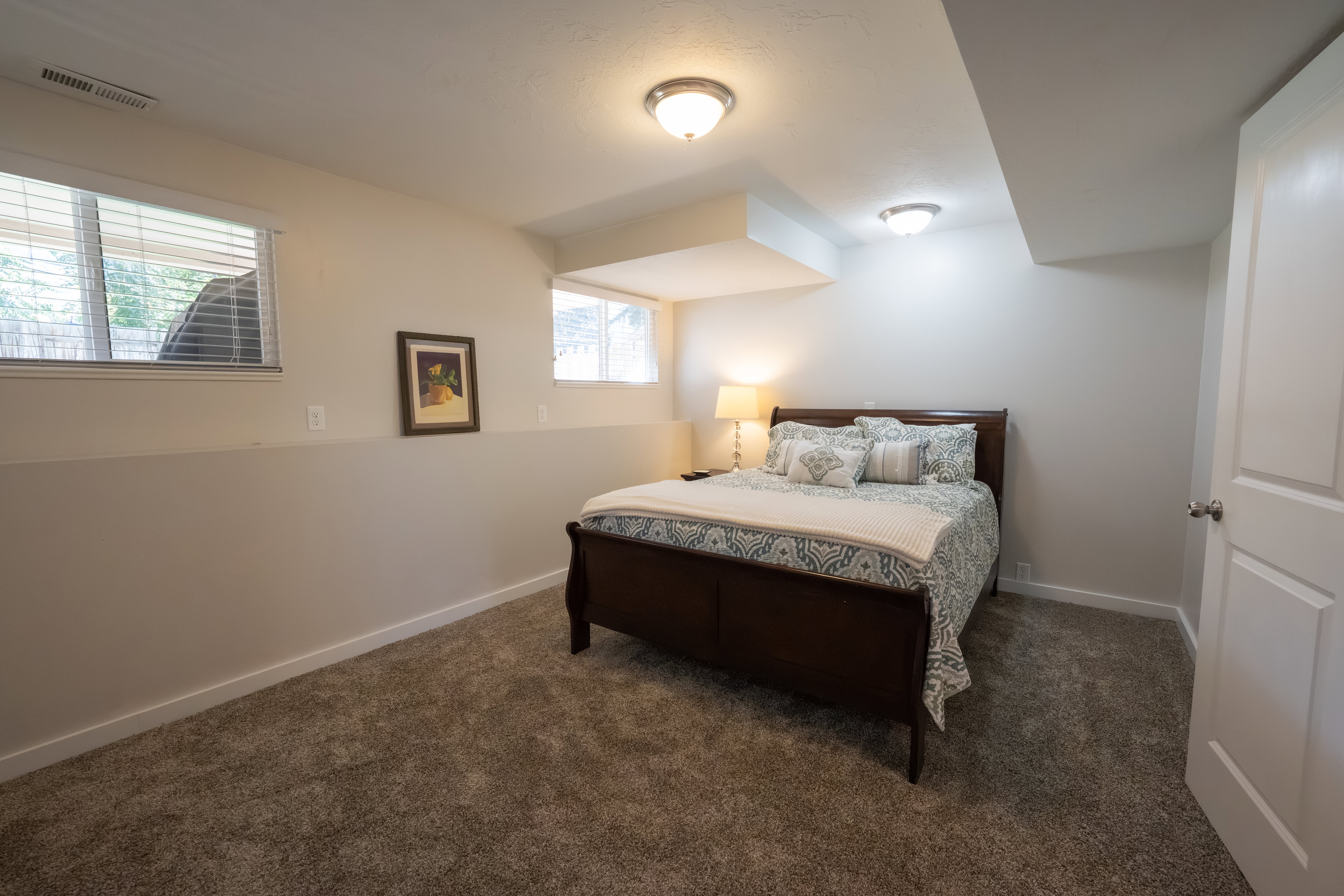 Bedroom featuring neutral carpeting, white trim, and light-colored walls