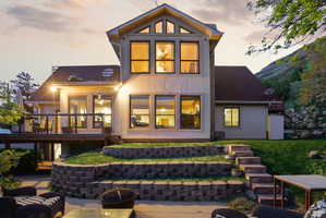 Rear stucco exterior with a multi-level deck featuring dark railings