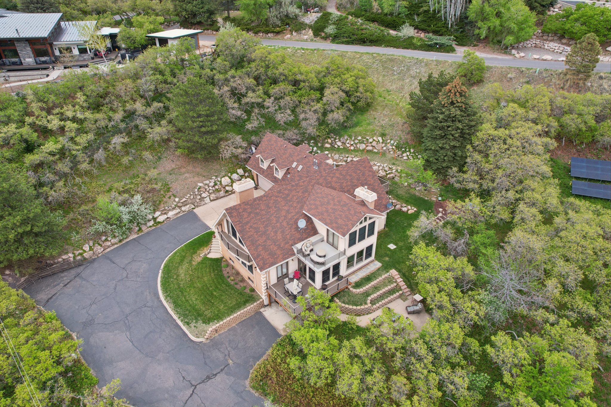 Two-story residence featuring a multi-gabled roofline and multiple dormer windows