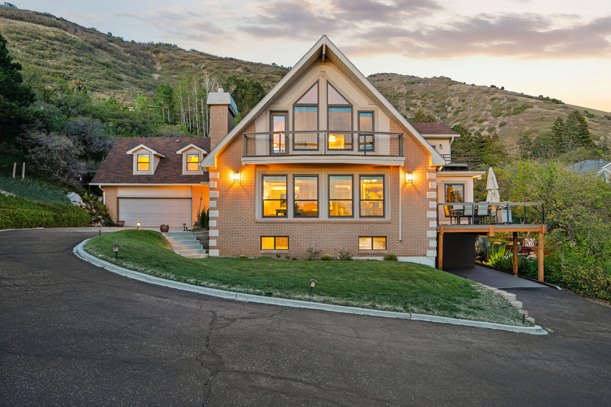 Brick exterior featuring a multi-story design with prominent gabled roofs and dormer windows
