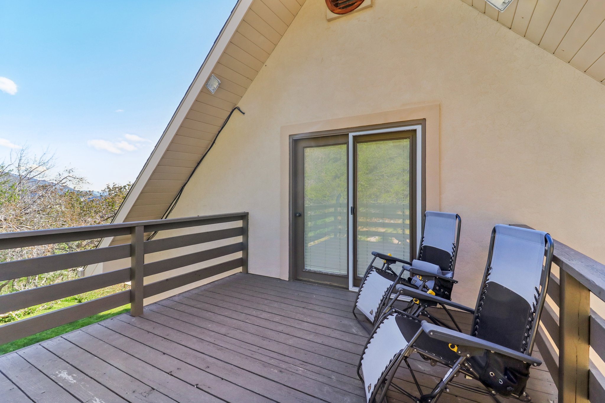 Exterior deck featuring wood-finish flooring, a wood railing, and a sliding glass door