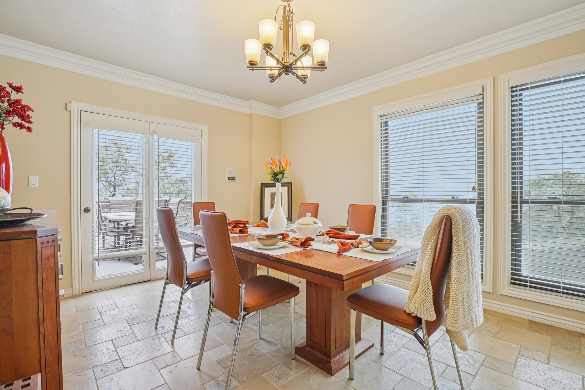 Dining area featuring tiled flooring, crown molding, double French doors, and large windows with blinds