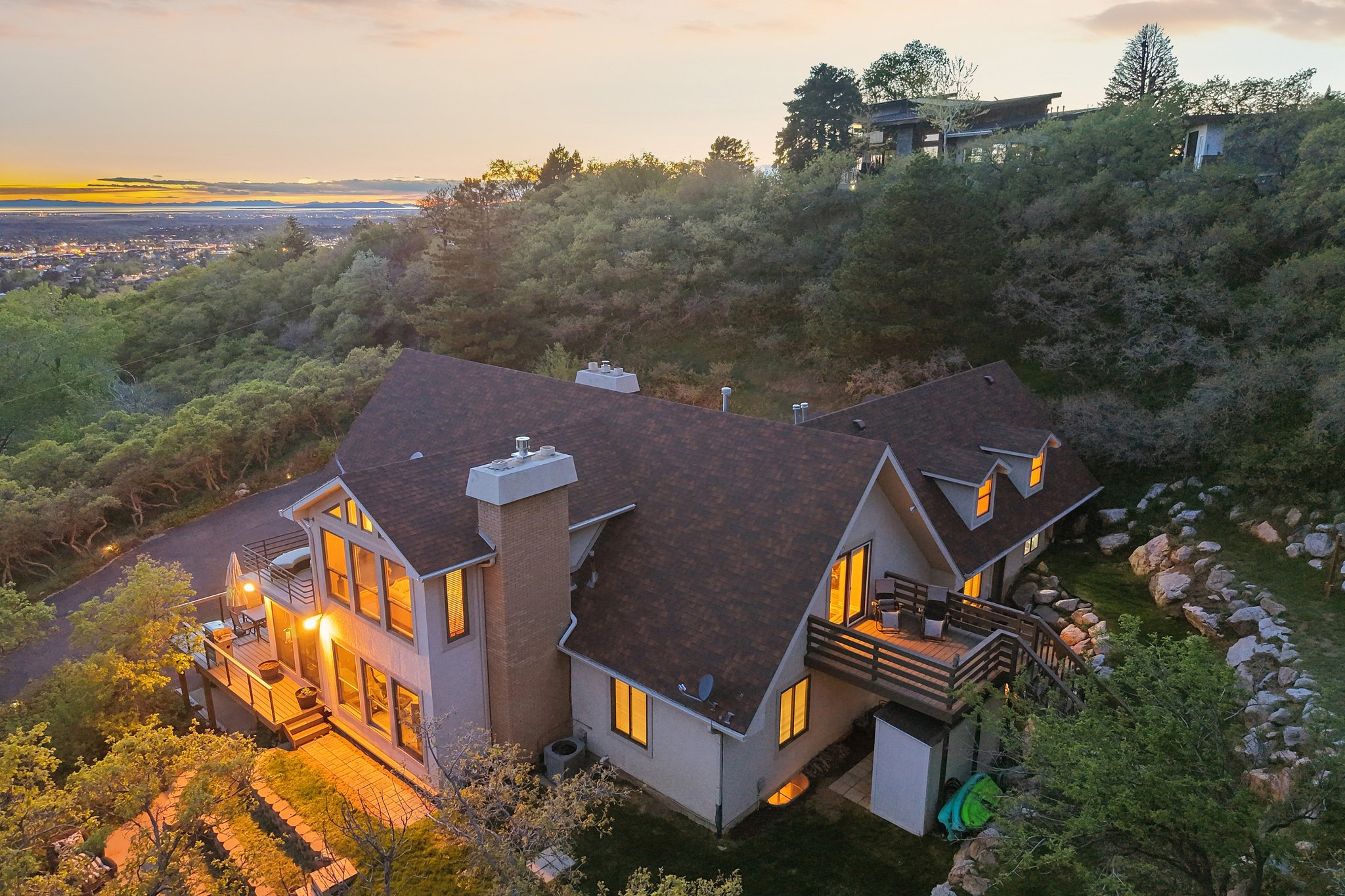 Multi-level residence featuring a steeply pitched roofline and light-colored siding