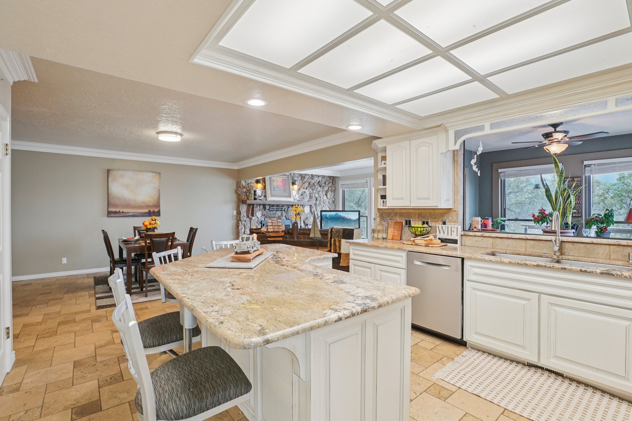 Kitchen island featuring a granite countertop and white cabinetry