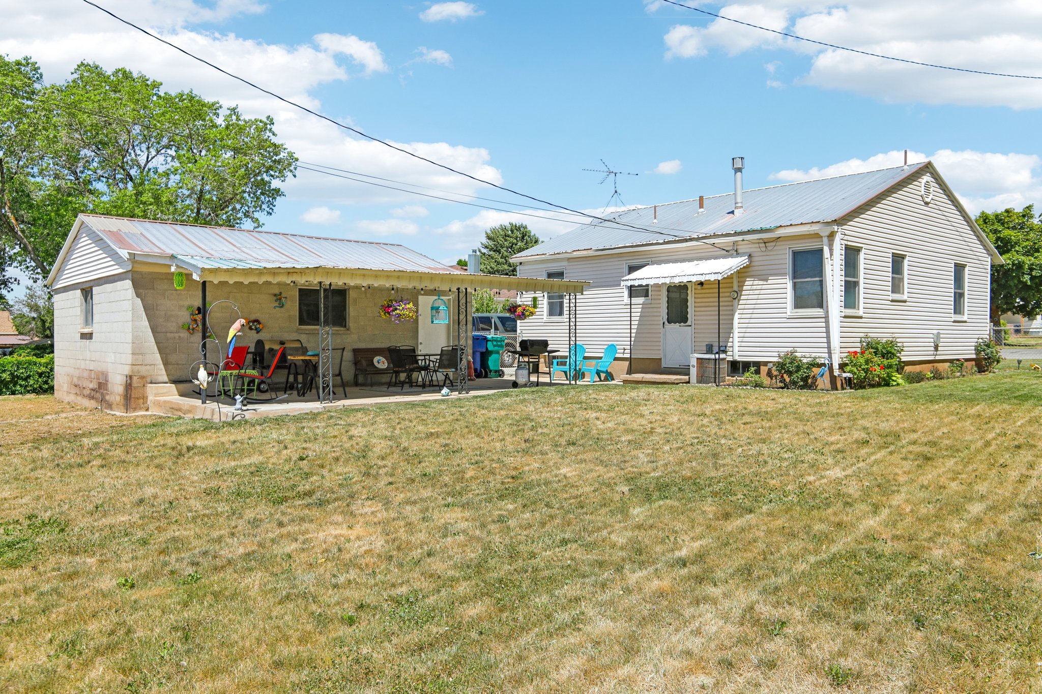 Detached structure featuring a covered patio with metal awning, block construction, and a metal roof
