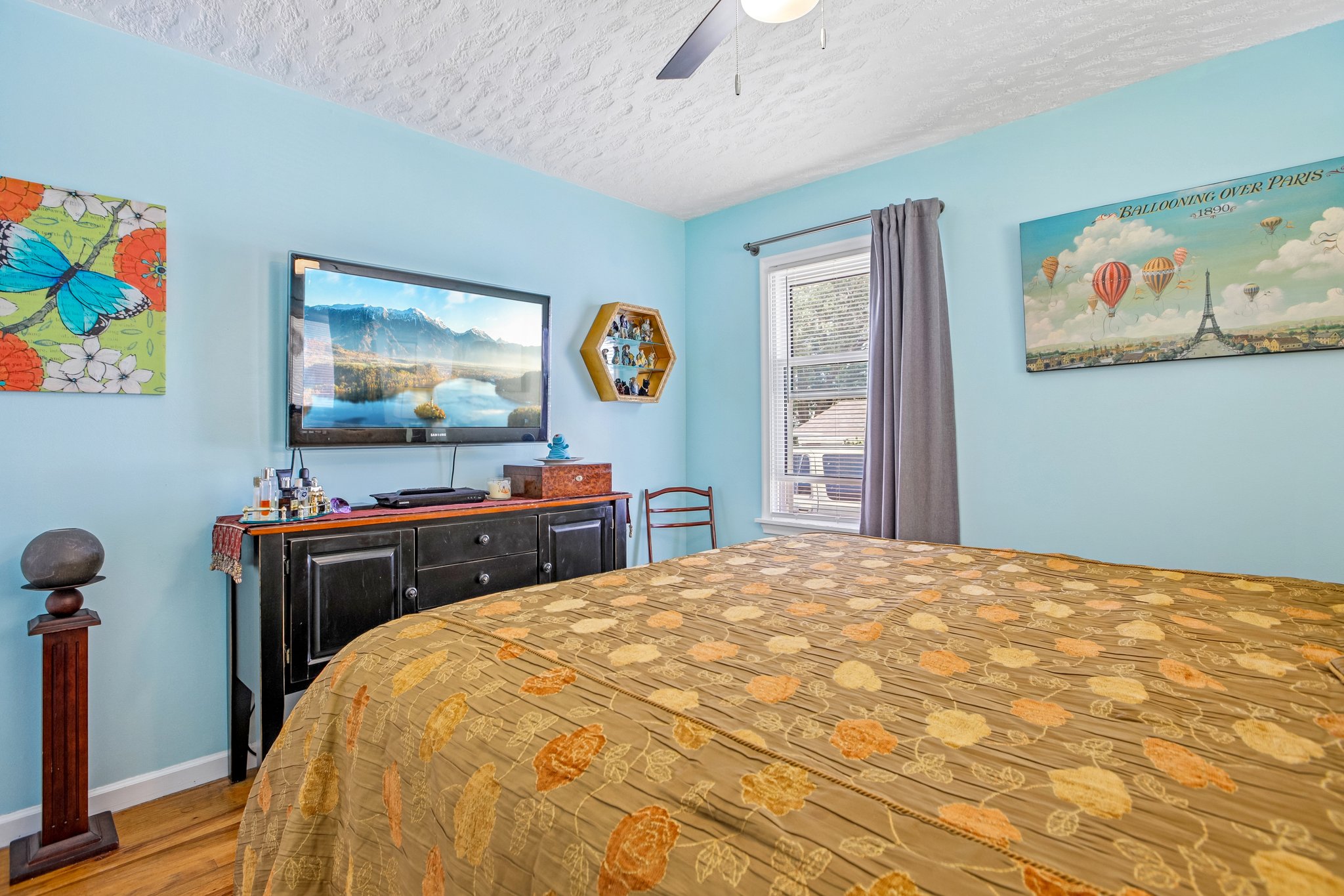 Room featuring light blue walls and wood-finish flooring