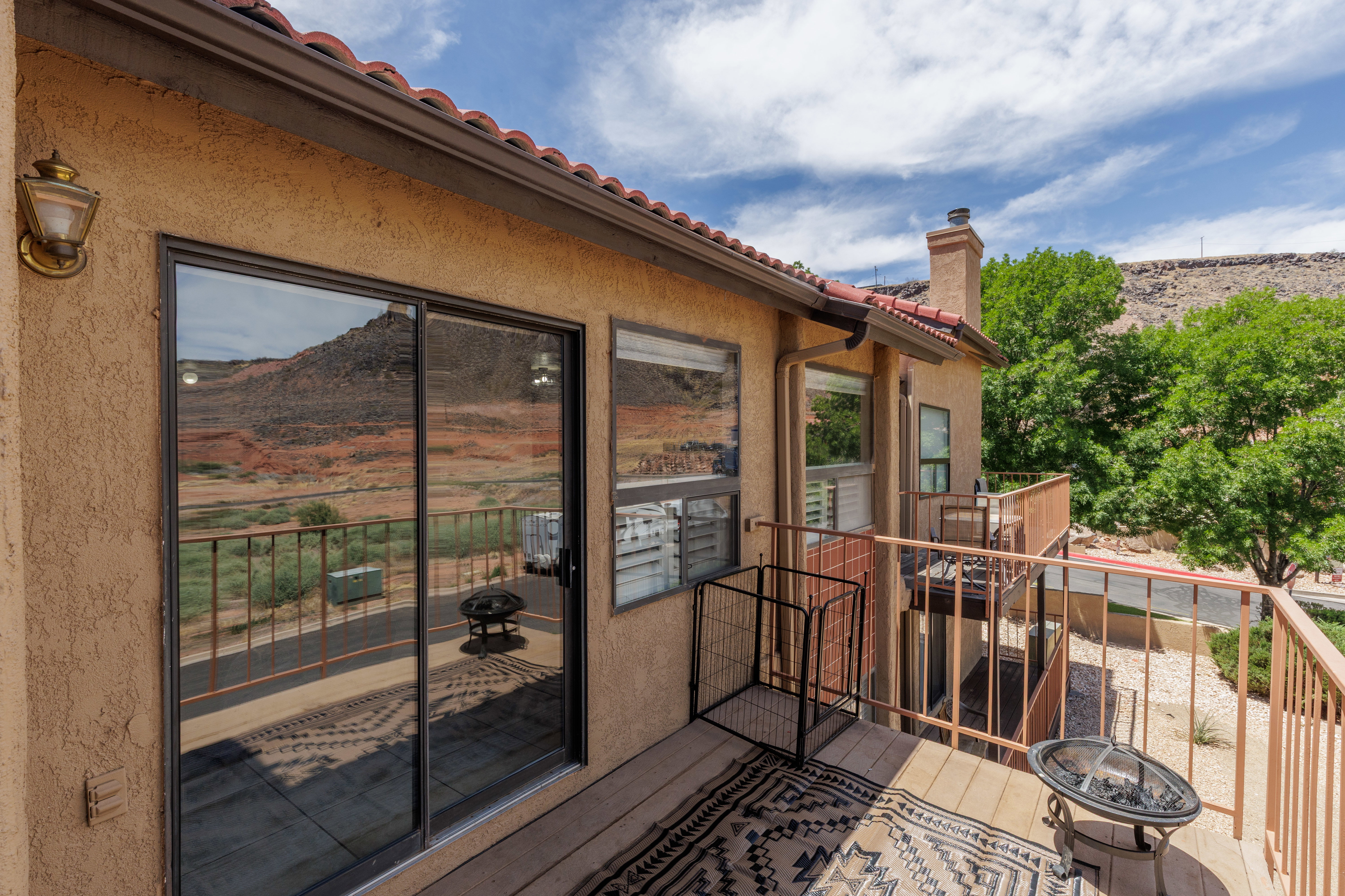 Terracotta roof tiles complement stucco exterior on outside deck
