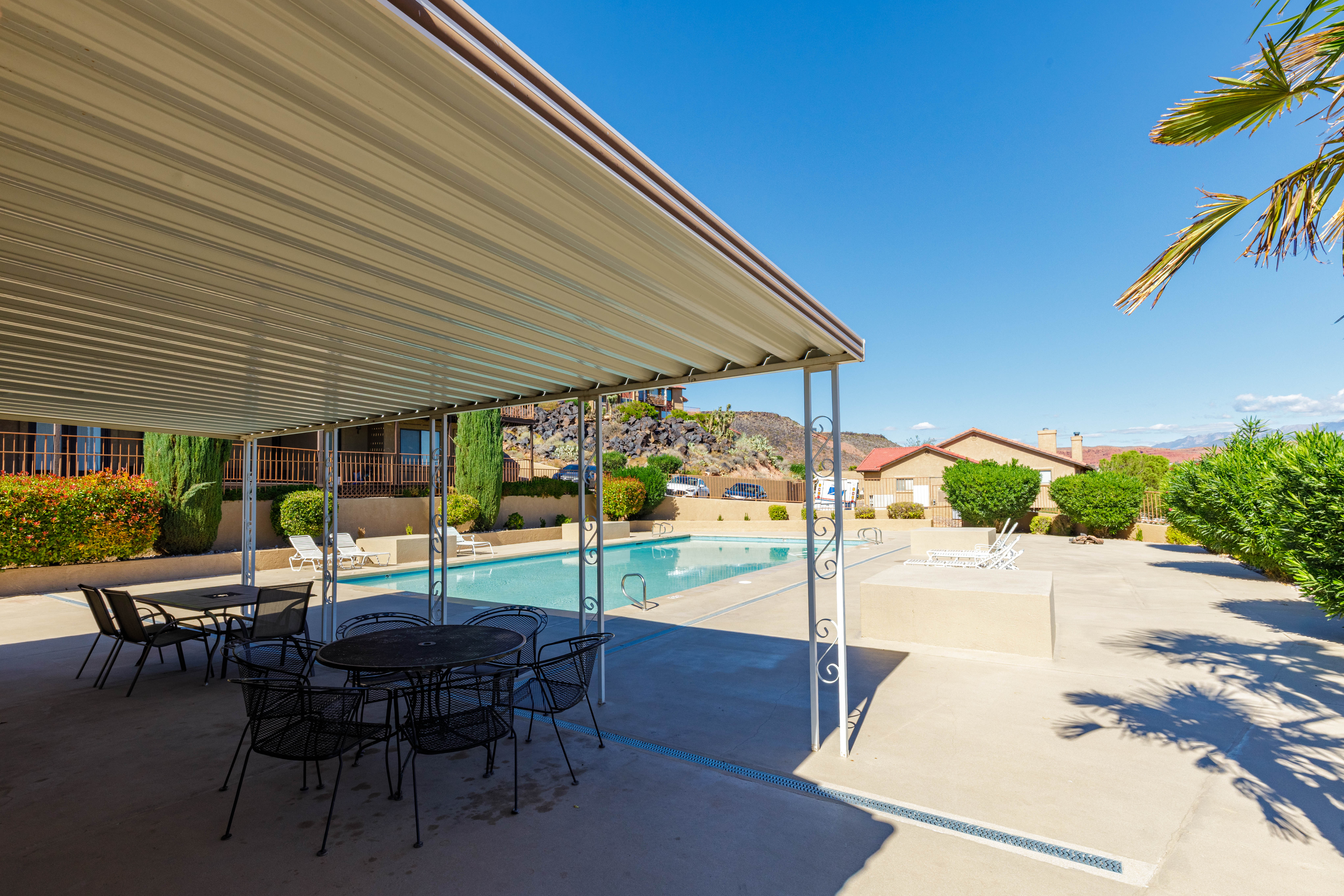 Shaded patio area and refreshing outdoor swimming pool