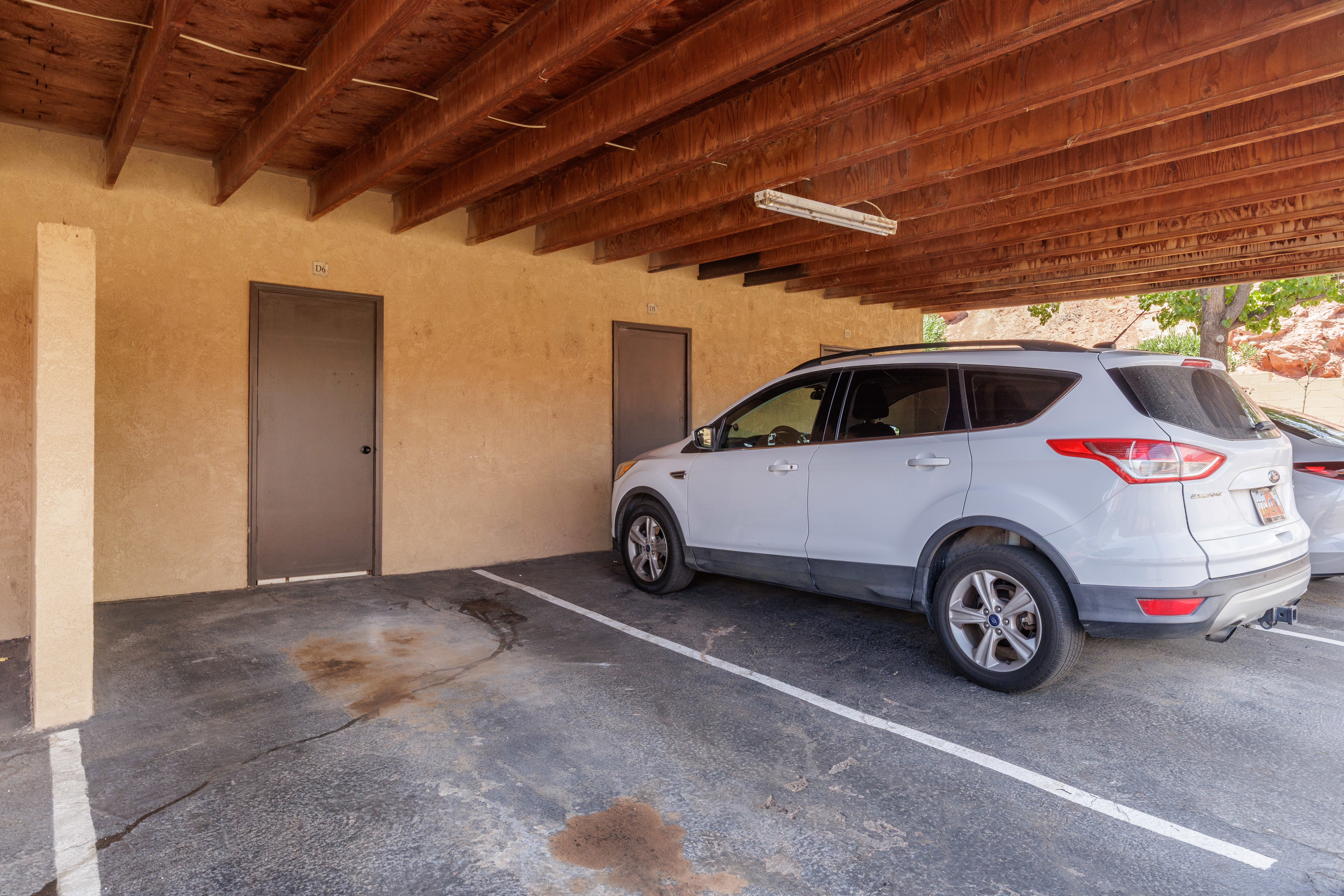 Covered parking space with storage room