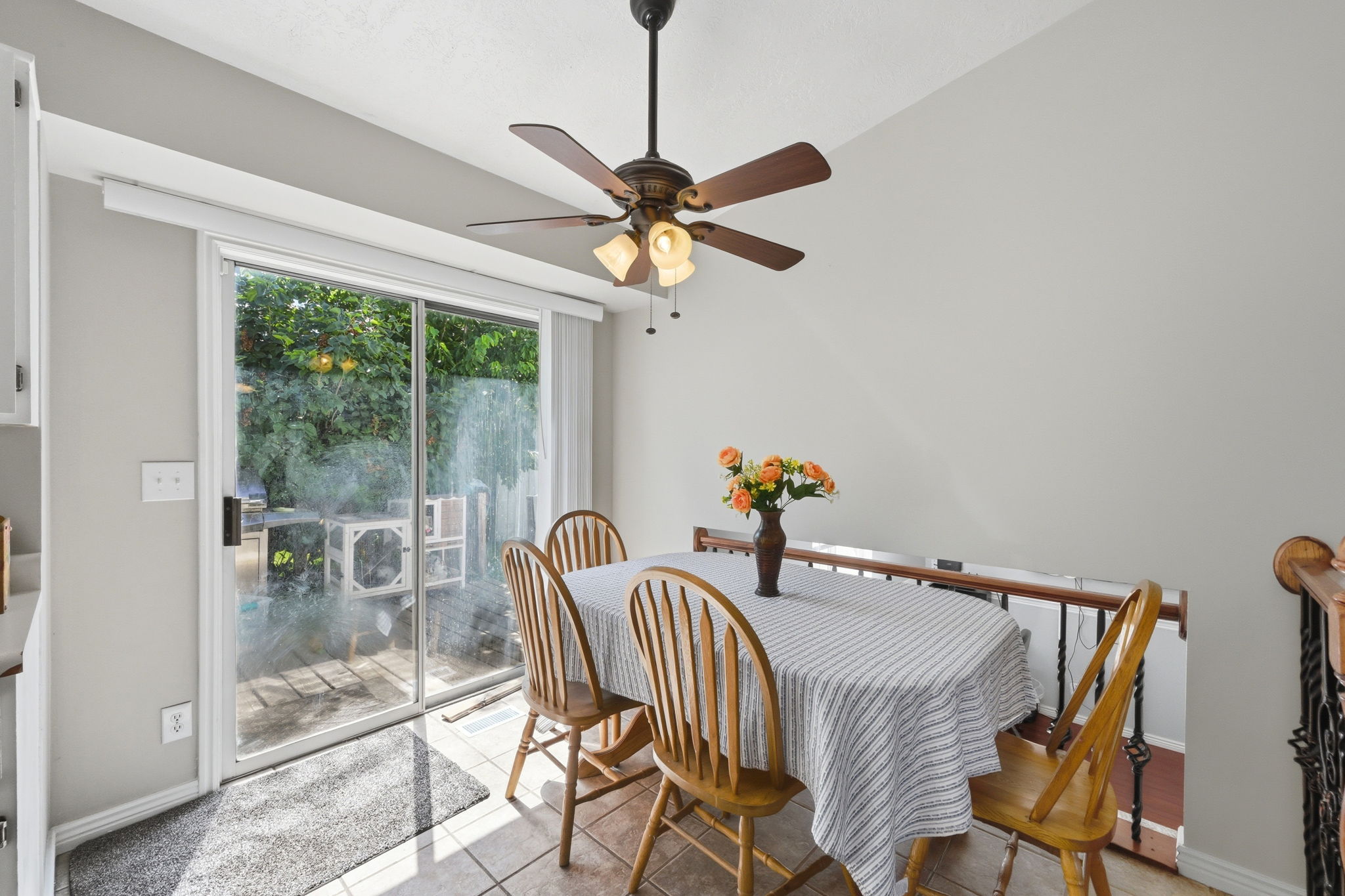 Tiled flooring with a white sliding patio door opening to outdoor space
