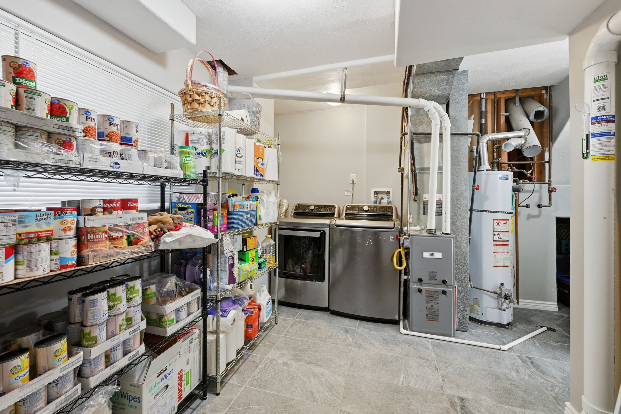 Dedicated laundry area with tile flooring and a window