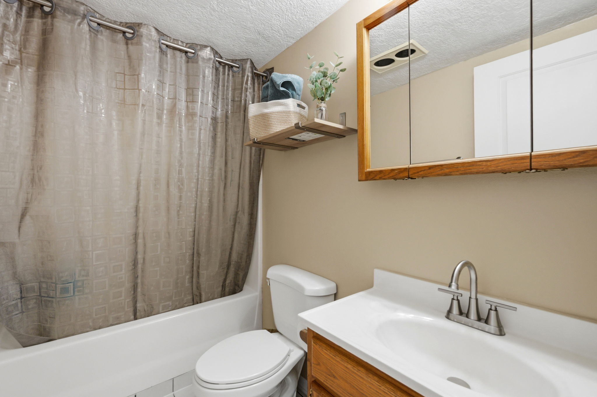 Bathroom featuring a white bathtub, toilet, and vanity with a white countertop