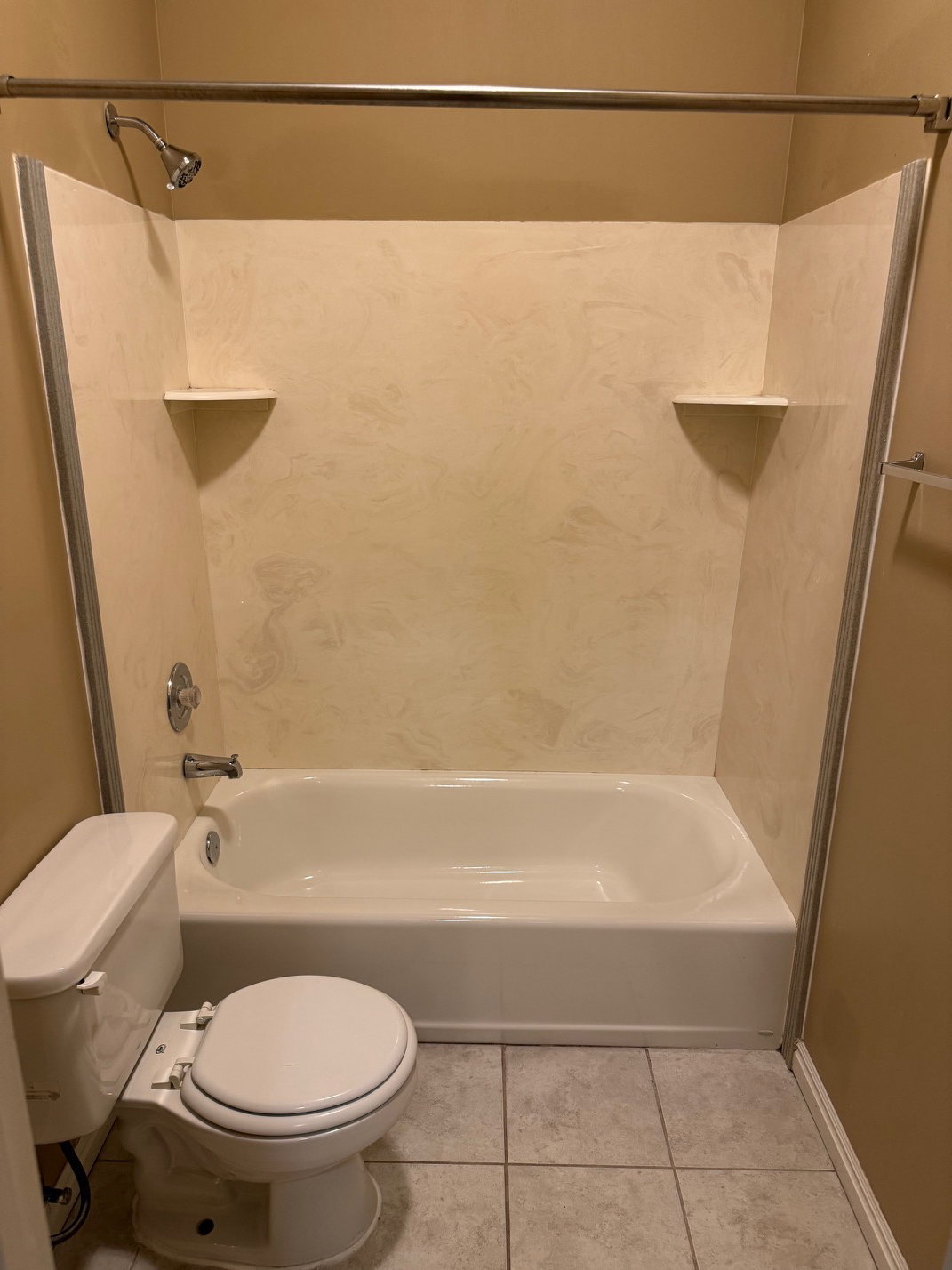 White bathtub and shower combination unit with integrated wall panels