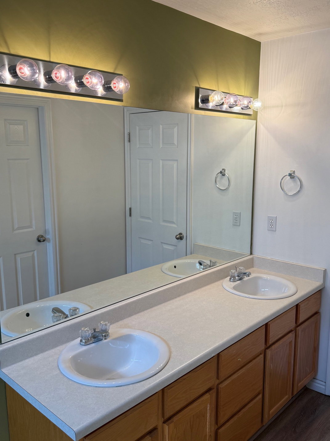 Master Bathroom w/ dual vanity with integrated sinks, laminate countertop, and wood-finish cabinetry