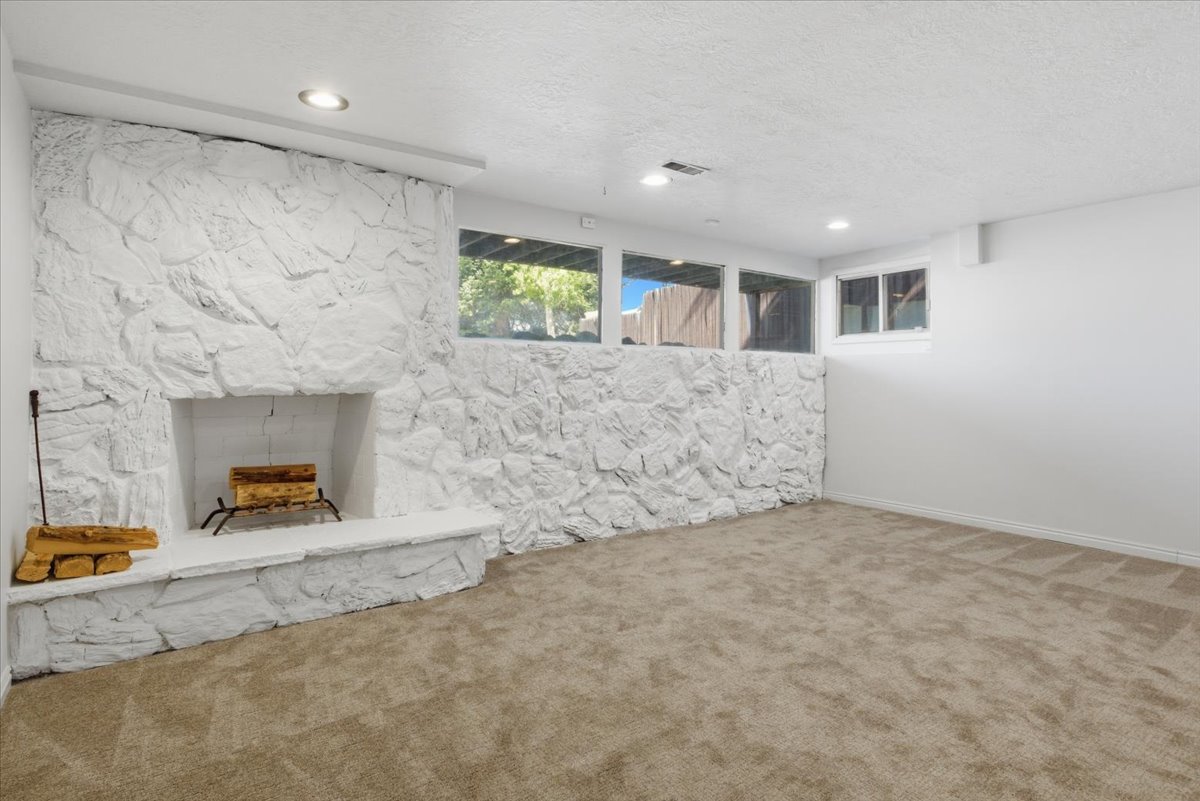 Living space featuring a white stone-clad fireplace and hearth