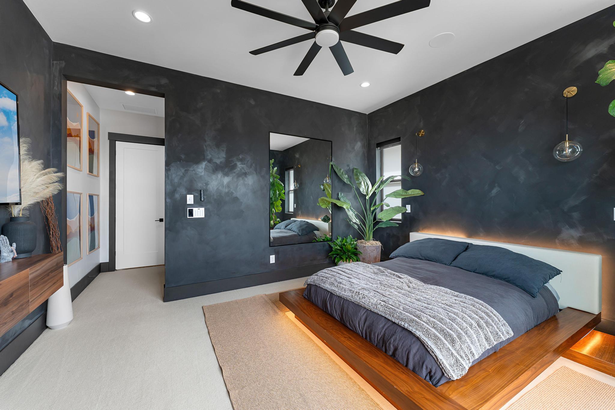 Bedroom featuring a dark accent wall, recessed lighting, and a contemporary ceiling fan