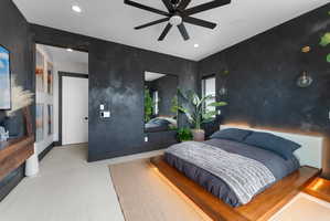 Bedroom featuring a dark accent wall, recessed lighting, and a contemporary ceiling fan