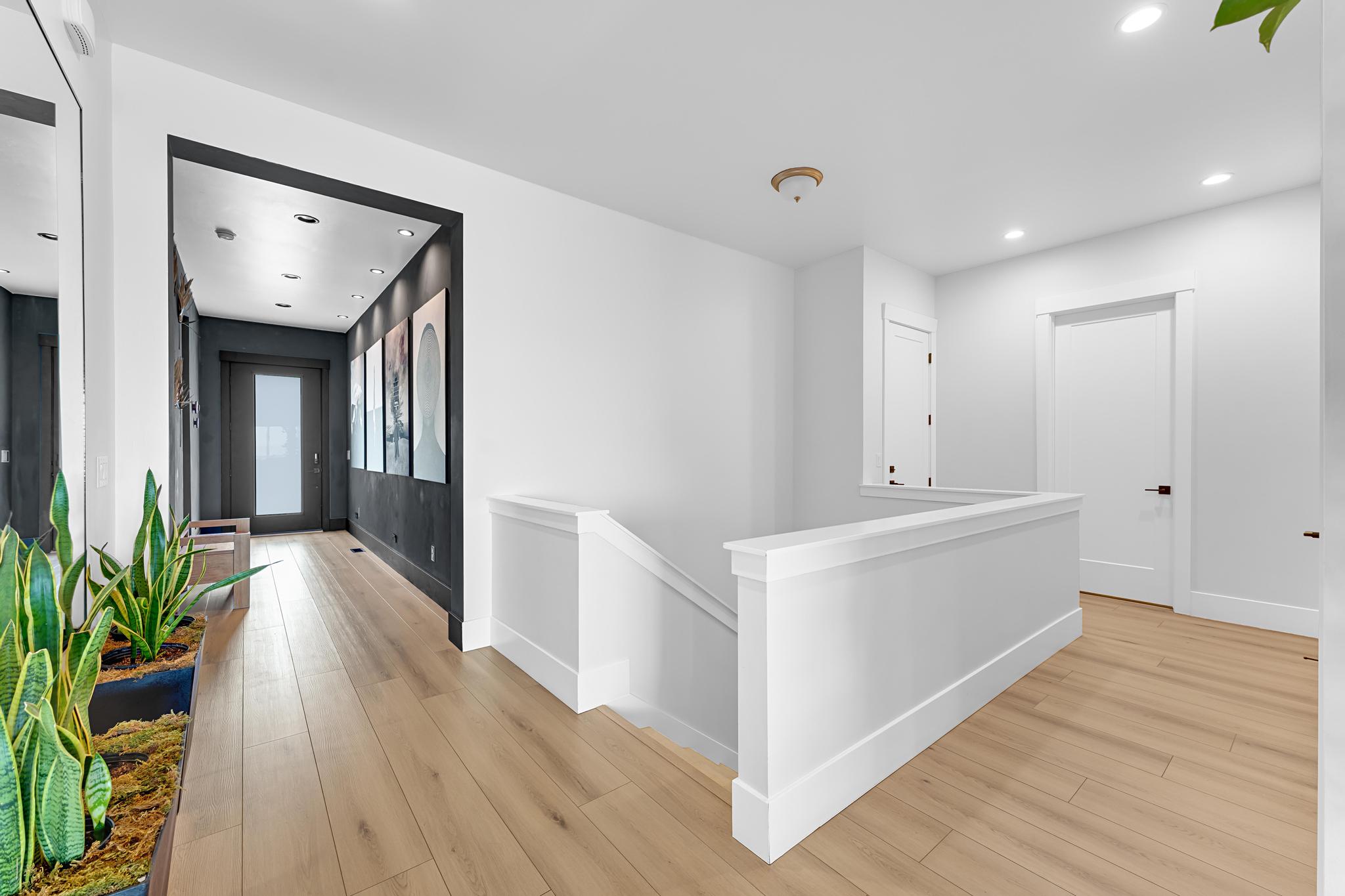 Light wood-finish flooring throughout the upper hallway and entryway