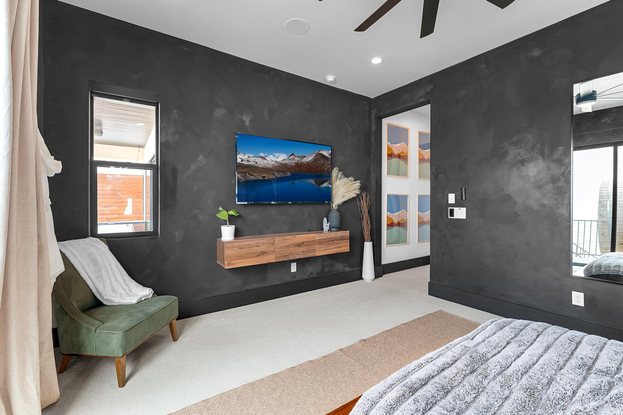 Bedroom featuring dark textured walls and light flooring