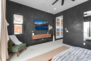 Bedroom featuring dark textured walls and light flooring
