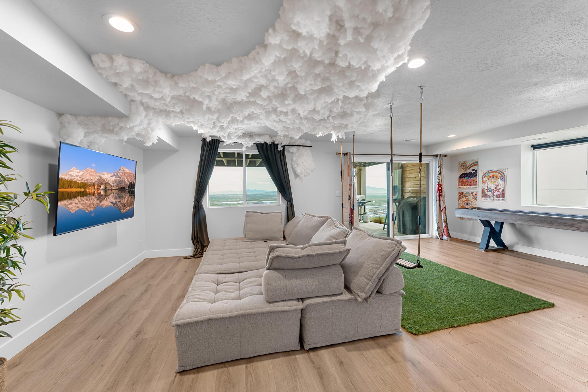 Spacious entertainment room featuring wood-finish flooring and recessed lighting