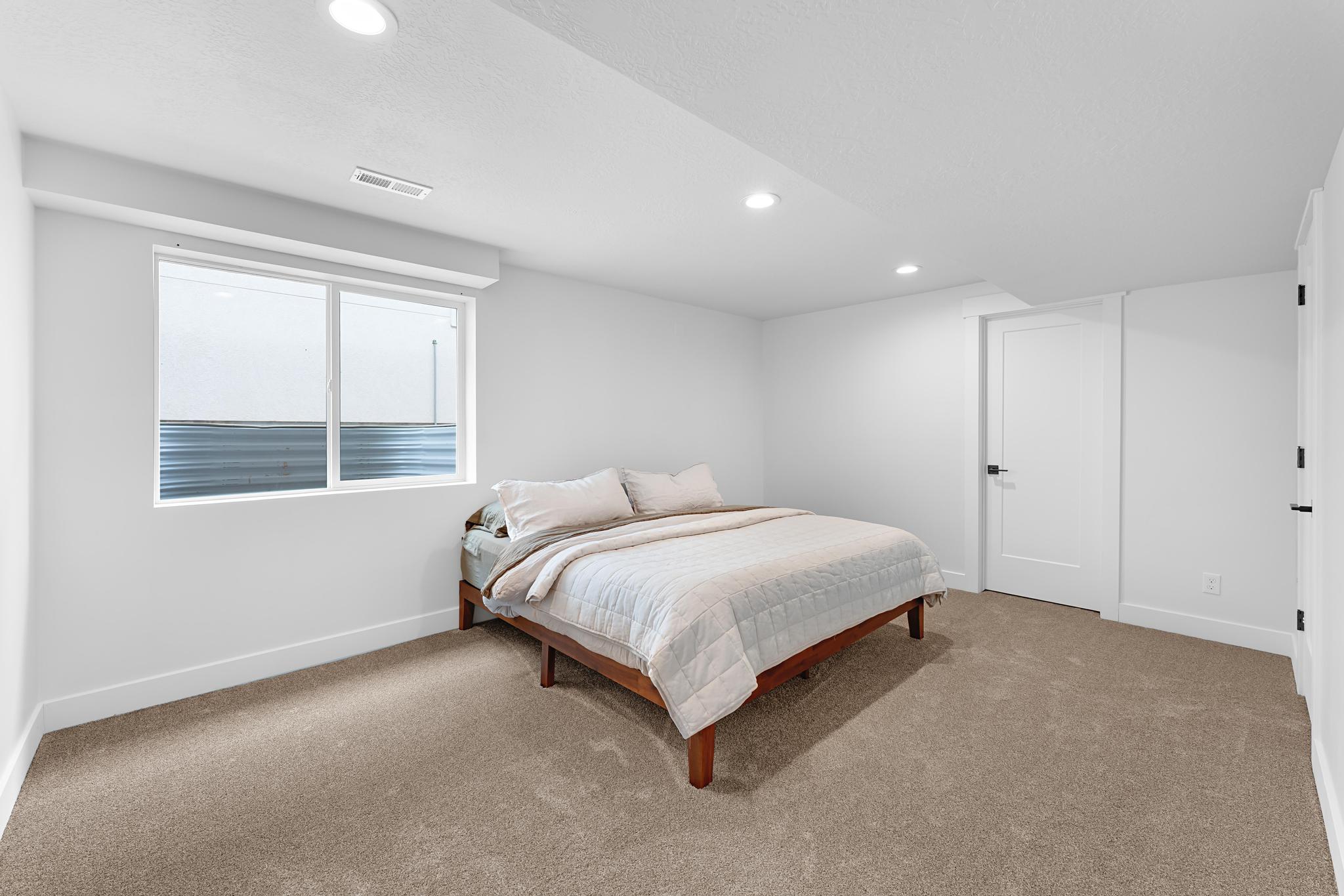 Carpeted room featuring a double window, recessed lighting, and white baseboards